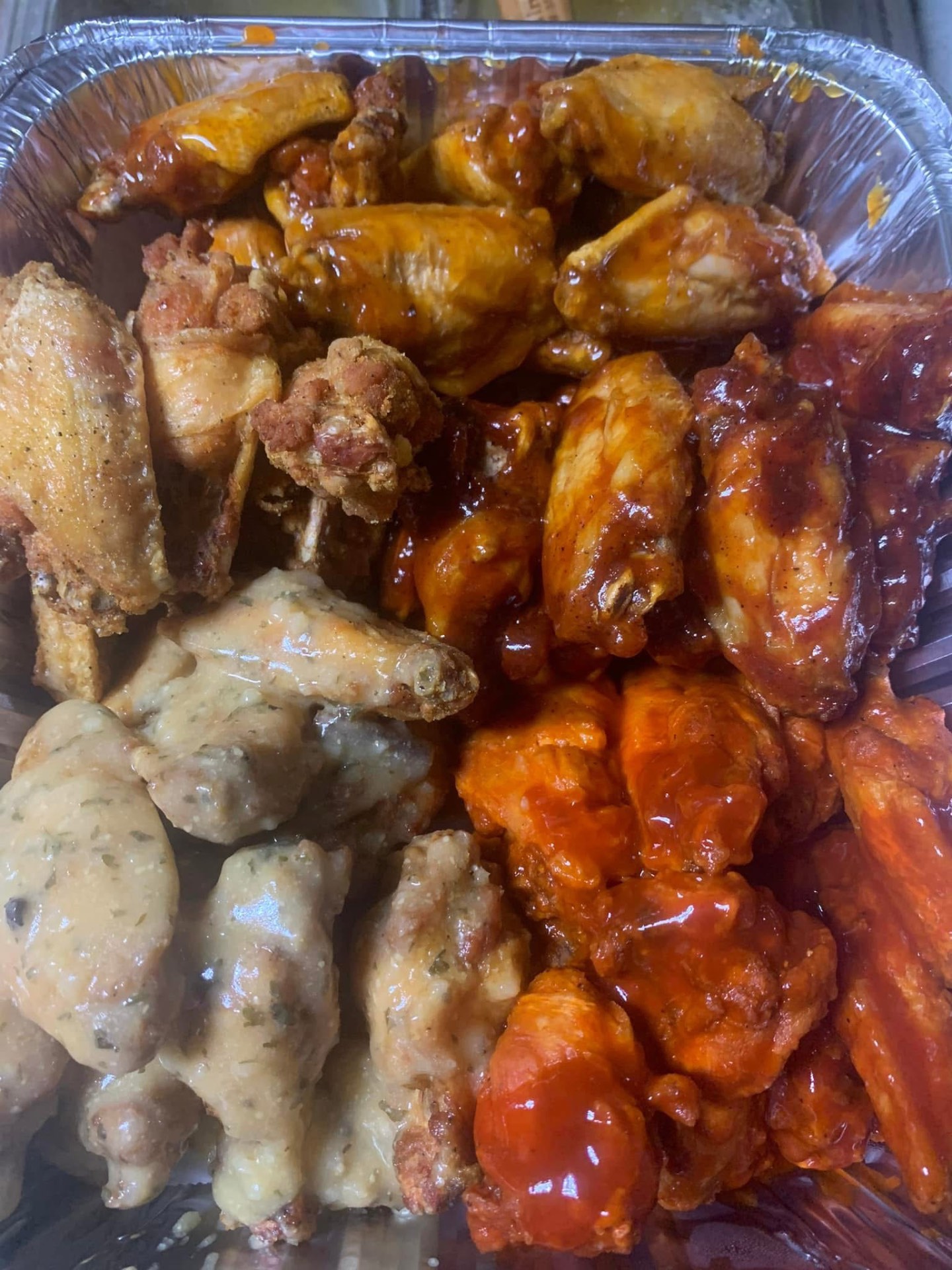 Variety of saucy chicken wings
